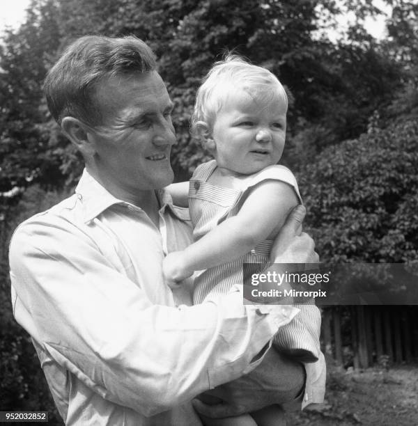 Manchester City footballer Don Revie pictured with his son Duncan in the back garden of the family home, 4th August 1955.