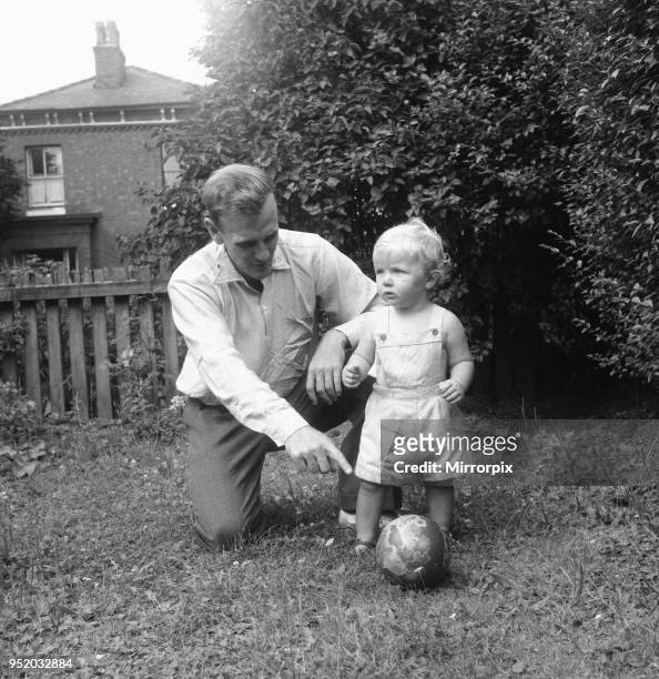 Manchester City footballer Don Revie pictured with his son Duncan in the back garden of the family home, 4th August 1955.