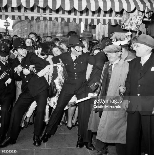 The Beatles A Hard Day's Night royal film premiere at the London Pavillion Theatre in Piccadilly Circus, London. Police trying to restrain crowds...