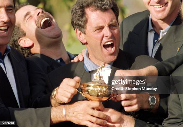 Joy for the European team as captain Bernard Gallacher and team member Sam Torrance get their hands on the trophy after victory in the Ryder Cup at...