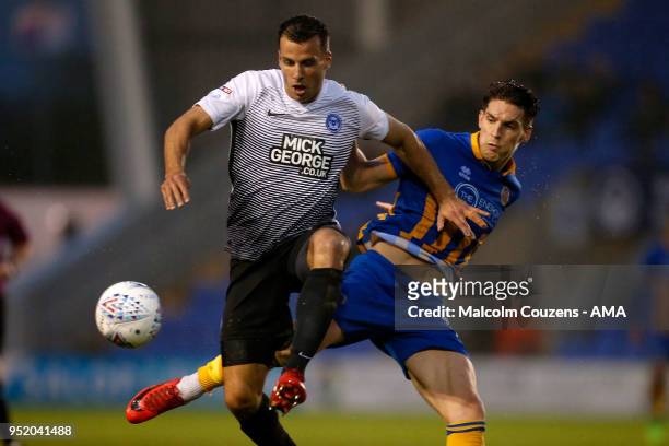 Steven Taylor of Peterborough United competes with Sam Jones of Shrewsbury Town during the Sky Bet League One match between Shrewsbury Town and...