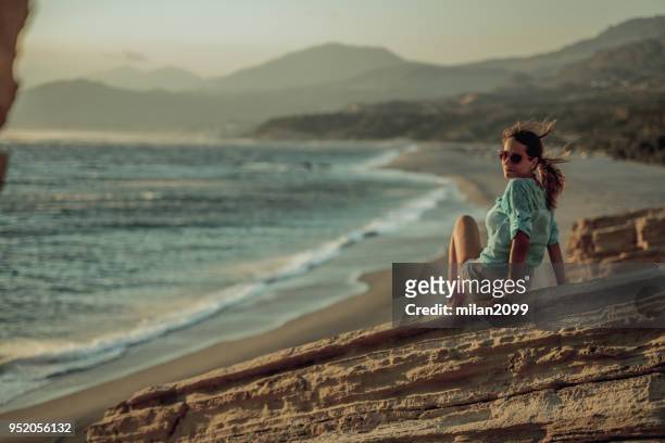 young woman looking at the beach landscape - crete woman stock pictures, royalty-free photos & images