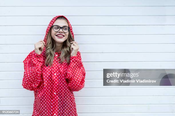 young woman in red outfit - windbreak stock pictures, royalty-free photos & images