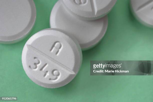photo of five pills of oxycocone. - opioid epidemic stock pictures, royalty-free photos & images