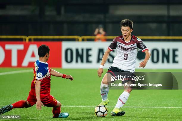 Chen Ching-hsuan of Hang Yuen FC is tackled by Ri Chang Ho of Hwaepul SC during the AFC Cup Group I match between Hang Yuen and Hwaepul at Fujen...