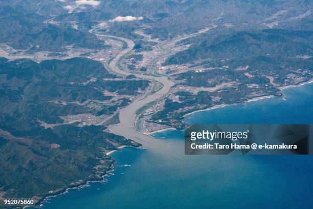 northern pacific ocean and shimanto river in kochi prefecture in japan daytime aerial view from airplane - präfektur kochi stock-fotos und bilder