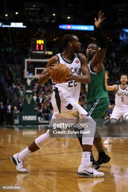 Khris Middleton of the Milwaukee Bucks handles the ball while being guarded by Terry Rozier of the Boston Celtics in the third quarter during Game...