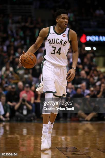 Giannis Antetokounmpo of the Milwaukee Bucks dribbles the ball in the fourth quarter against the Boston Celtics during Game Six of Round One of the...