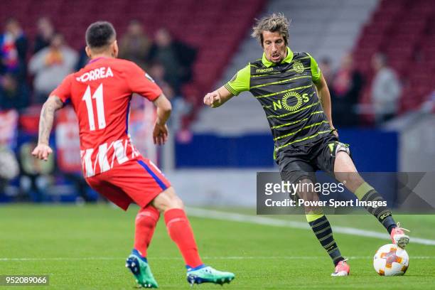 Fabio Coentrao of Sporting CP fights for the ball with Angel Correa of Atletico de Madrid during the UEFA Europa League quarter final leg one match...