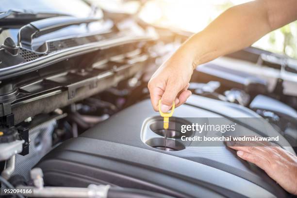 professional mechanic checking car engine - motor oil stockfoto's en -beelden