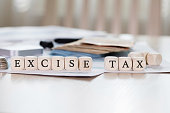Word EXCISE TAX is composed of wooden letters.