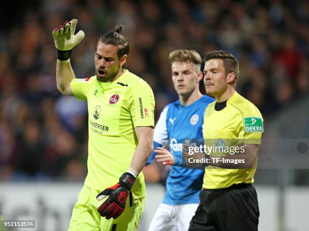 Goalkeeper Thorsten Kirschbaum of Nuernberg gestures and Marvin Ducksch of Kiel and referee Harm Osmers look on during the Second Bundesliga match...