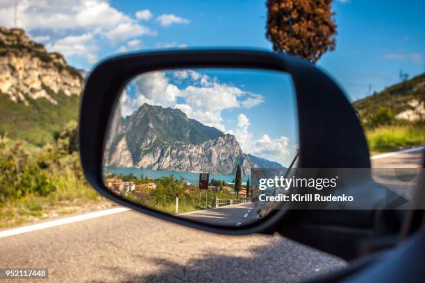 a reflection in a car's mirror at lake garda, italy - garda stockfoto's en -beelden