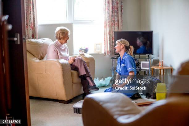 healthcare nurse on a house call - welfare stock pictures, royalty-free photos & images