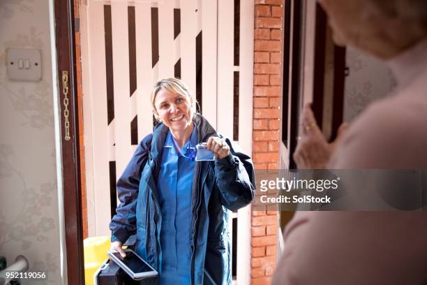 nurse at the door making a house call - visit stock pictures, royalty-free photos & images