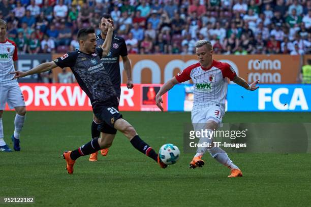 Suat Serdar of Mainz and Philipp Max of Augsburg battle for the ball during the Bundesliga match between FC Augsburg and 1. FSV Mainz 05 at WWK-Arena...
