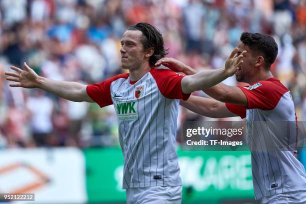 Michael Grogoritsch of Augsburg celebrates after scoring his team`s first goal Rani Khedira of Augsburg during the Bundesliga match between FC...