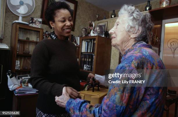 Aide à domicile livrant des repas préparés chez une femme âgée à Vitry-sur-Seine, en janvier 2001, dans le Val-de-Marne, France.