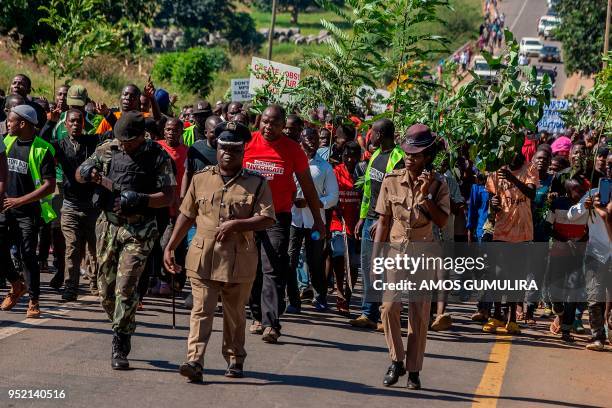 Malawian demonstrators march through the streets to protest against alleged poor governance of President Peter Mutharika's government in Lilongwe on...