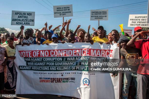 Malawian demonstrators march through the streets to protest against alleged poor governance of President Peter Mutharika's government in Lilongwe on...