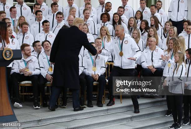 President Donald Trump shakes hands with Paralympic gold medalist in Sled Hockey Jen Lee during a celebration of the USA 2018 Winter Olympic and...