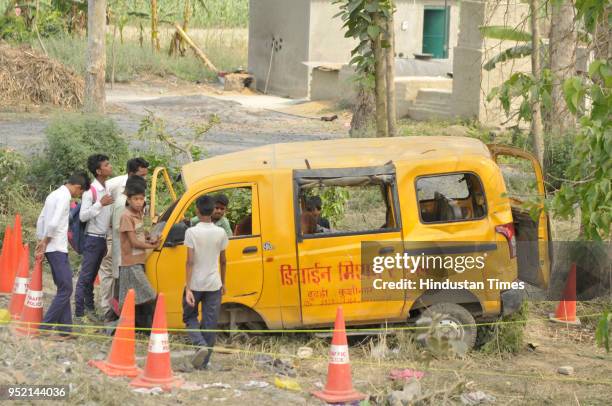 General view of the mangled remains of a school van after it was hit by a speeding train on April 27, 2018 in Kushinagar, India. 13 children, aged...