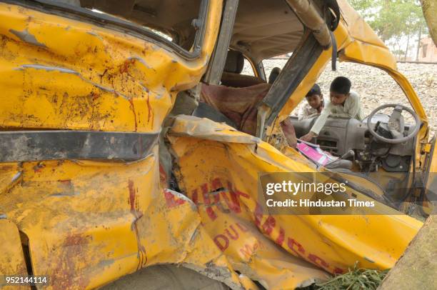 General view of the mangled remains of a school van after it was hit by a speeding train at an unmanned railway crossing on April 27, 2018 in...