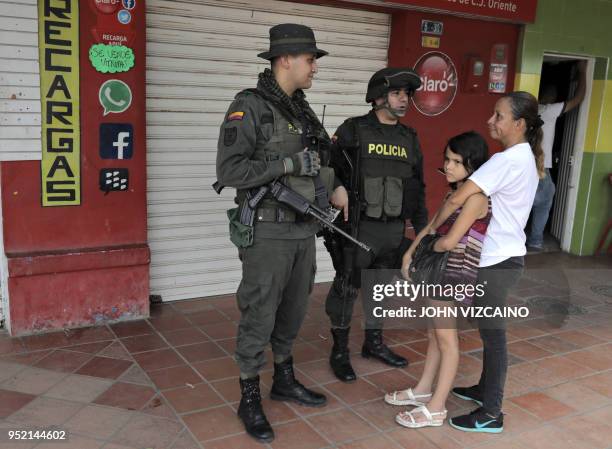 Police officer and a soldier patrolling the streets of Tibu, in the region of Catatumbo, Norte Santander Department, in northeastern Colombia, talk...