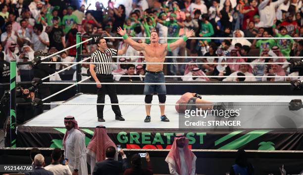John Cena celebrates defeating Triple H during the World Wrestling Entertainment Greatest Royal Rumble event in the Saudi coastal city of Jeddah on...