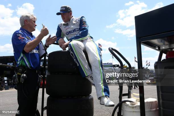 Ty Dillon, driver of the GEICO Chevrolet, talks to crew chief Matt Borland in the garage area during practice for the Monster Energy NASCAR Cup...