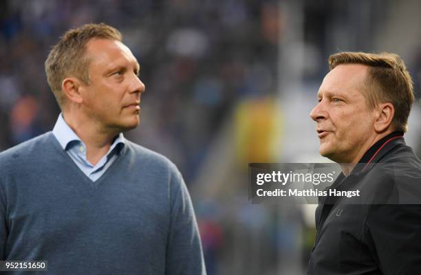 Head coach Andre Breitenreiter and sporting director Horst Heldt of Hannover look on prior to the Bundesliga match between TSG 1899 Hoffenheim and...