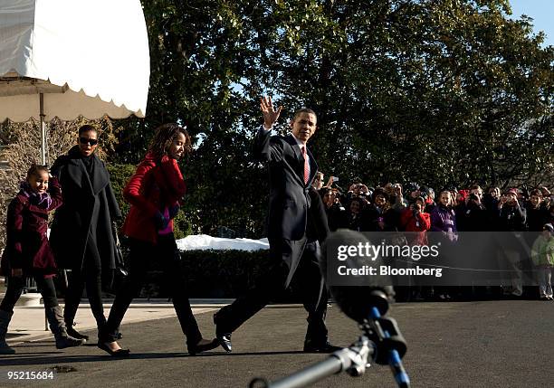 President Barack Obama, right, departs from the White House residence for a trip to Hawaii with his daughter Malia, from right, wife Michelle, and...