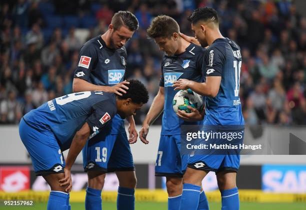 Andrej Kramaric of Hoffenheim celebrates with his injured team-mate Serge Gnabry of Hoffenheim after scoring his team's first goal during the...