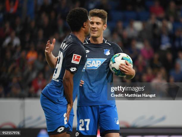 Andrej Kramaric of Hoffenheim celebrates with his injured team-mate Serge Gnabry of Hoffenheim after scoring his team's first goal during the...