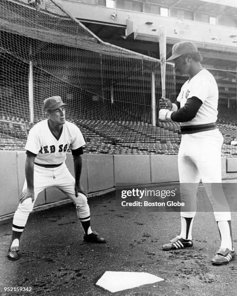 Boston Red Sox Johnny Pesky, left, and Jim Rice, right, warm up on the day of a game against the Detroit Tigers at Fenway Park in Boston, Sept. 9,...