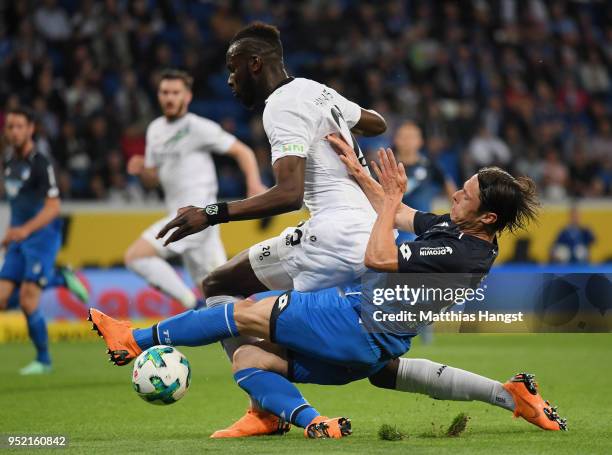 Salif Sane of Hannover and Nico Schulz of Hoffenheim compete for the ball during the Bundesliga match between TSG 1899 Hoffenheim and Hannover 96 at...