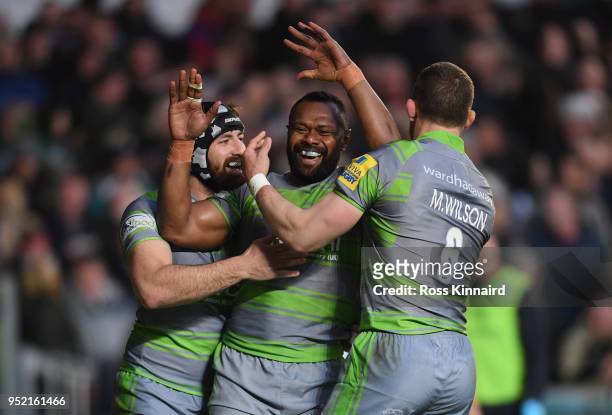 Vereniki Goneva of Newcastle Falcons is congratulated by team-mates after scoring a try during the Aviva Premiership match between Leicester Tigers...