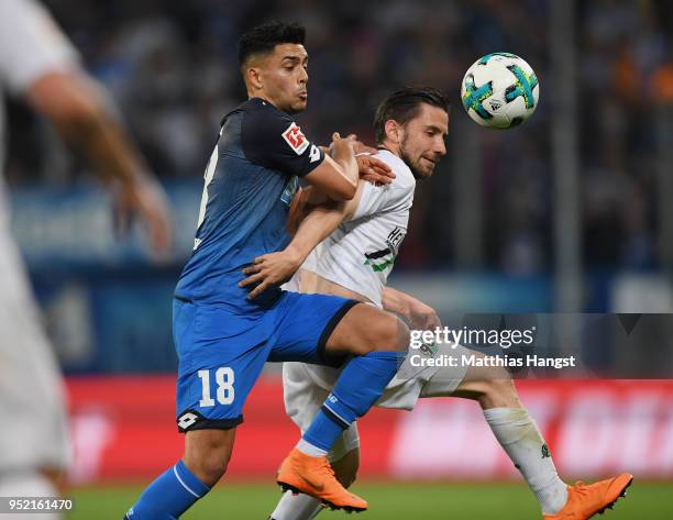 Nadiem Amiri of Hoffenheim and Julian Korb of Hannover compete for the ball during the Bundesliga match between TSG 1899 Hoffenheim and Hannover 96...