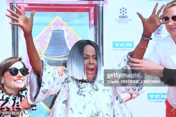 Actress Cicely Tyson shows her hands after imprinting them into the cement during her Hand and Footprints Ceremony at the TCL Chinese Theater in...
