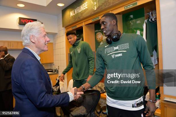 Milwaukee, WI Former President of the United States of America Bill Clinton shakes hands with Tony Snell of the Milwaukee Bucks prior to Game Six of...