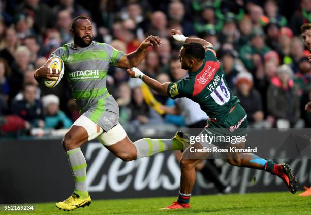 Vereniki Goneva of Newcastle Falcons burstes past Telusa Veainu of Leicester Tigers to score the opening try during the Aviva Premiership match...