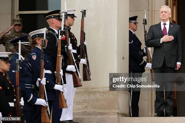 Defense Secretary James Mattis puts his hand over his heart during the playing of the national anthem as he hosts an Enhanced Honor Cordon for Polish...