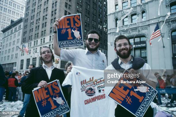 Three fans of the New York Mets at a ticker tape parade for the baseball team after their victory in the World Series, 28th October 1986.