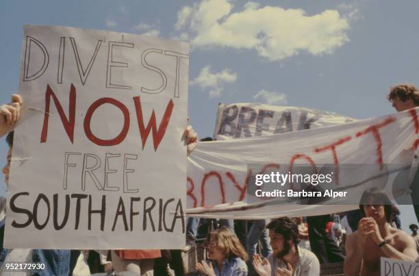 Student anti-Apartheid protesters with placards urging Harvard University to divest itself of investments in South Africa, Cambridge, Massachusetts,...