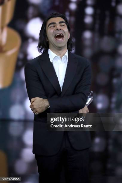 Fatih Akin reacts to winning the silver award 'Best Picture' for the movie 'Aus dem Nichts' on stage during the Lola - German Film Award show at...