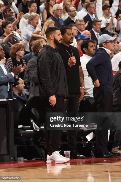 Drake looks on curtsied during Game Five of the Eastern Conference Quarterfinals during the 2018 NBA Playoffs between the Washington Wizards and...