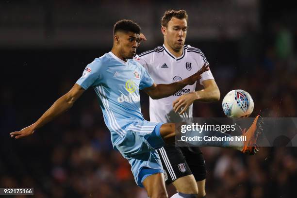 Ashley Fletcher of Sunderland controls the ball under a challenge by Kevin McDonald of Fulham FC during the Sky Bet Championship match between Fulham...