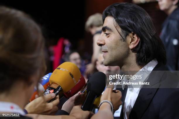 Award winner Fatih Akin is interviewed during the Lola - German Film Award show at Messe Berlin on April 27, 2018 in Berlin, Germany.