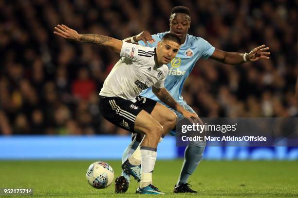 Aleksandar Mitrovic of Fulham tangles with Lamine Kone of Sunderland during the Sky Bet Championship match between Fulham and Sunderland at Craven...