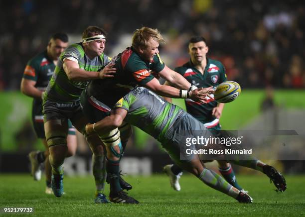 Luke Hamilton of Leicester Tigers is tackled by Sam Lockwood of Newcastle Falcons during the Aviva Premiership match between Leicester Tigers and...